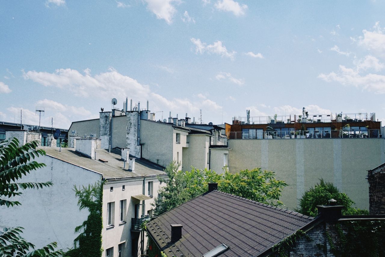 A picturesque view of Kraków's residential rooftops on a bright and sunny day.